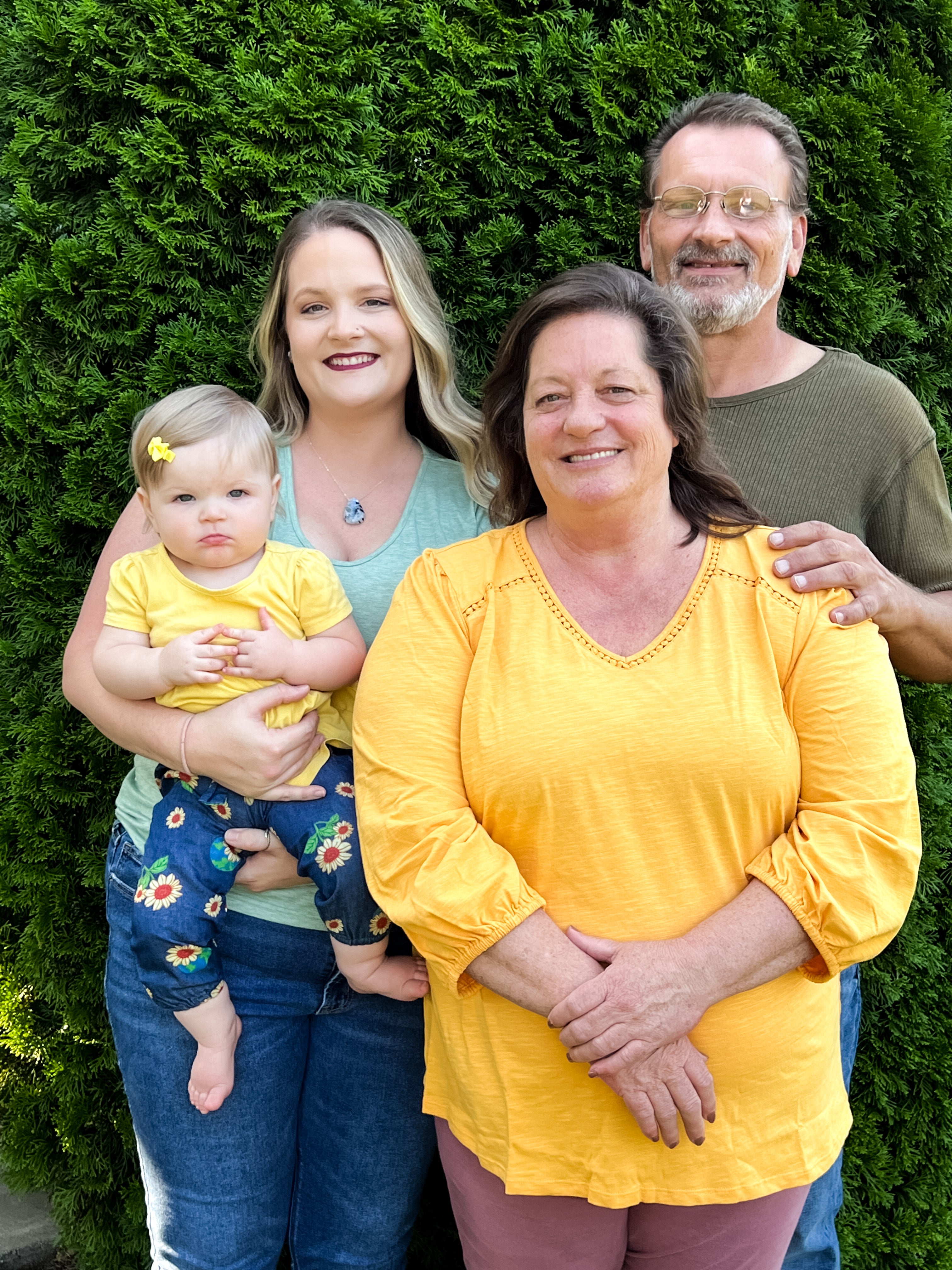Marissa, Laurie, Jim and Marissa’s daughter standing together for a family portrait